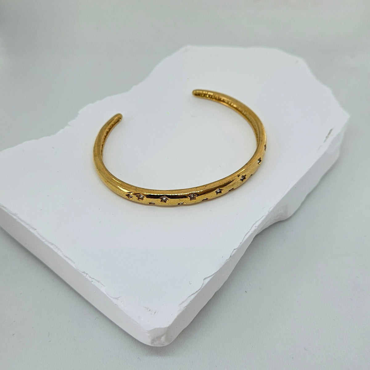 Gold bracelet with white stars photo